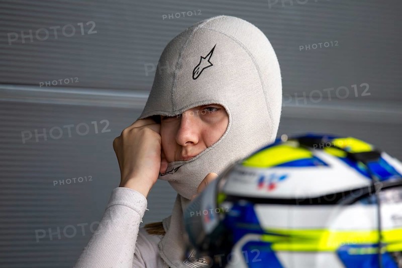 10 May 2024, Hockenheimring Germany : Spanish racing driver Alba Vazquez puts on her balavlava and gets ready to get into the cockpit (GT Open)