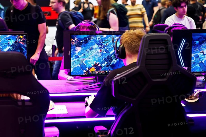 Visitors in front of screens with a computer game, Gamescom trade fair, the world's largest trade fair for computer games and consumer electronics, Cologne, Germany, Europe