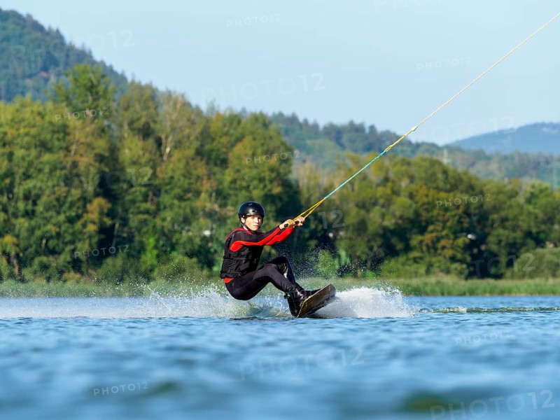 Young man doing sports with wakeboard in lake, water sports, water skiing in wakepark, Stráž pod Ralskem, Czech Republic, Europe