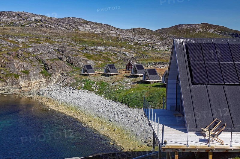 Modern wooden cabins with solar panels on a rocky coastal landscape in nature, Tourimus, Ilimanaq, Disko Bay, Arctic, Greenland, Denmark, North America