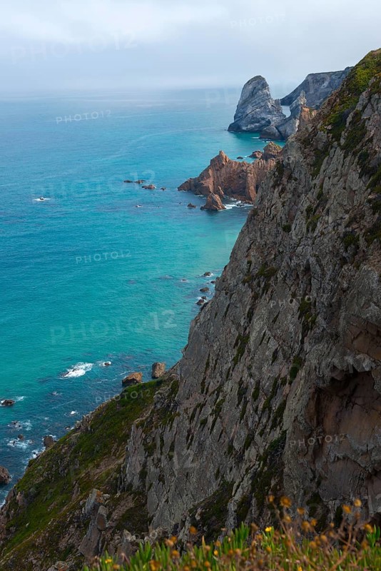 View from a cliff onto the turquoise blue sea and rocky coast, Cape Cabo da Roca, westernmost point of the European mainland, Atlantic coast, Sintra, Lisbon, Lisboa, Portugal, Europe