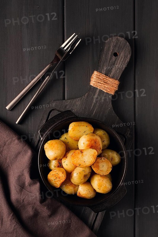 Fresh Cooked, new potatoes, with dill, on a wooden table, selective focus. close-up, toning, no people