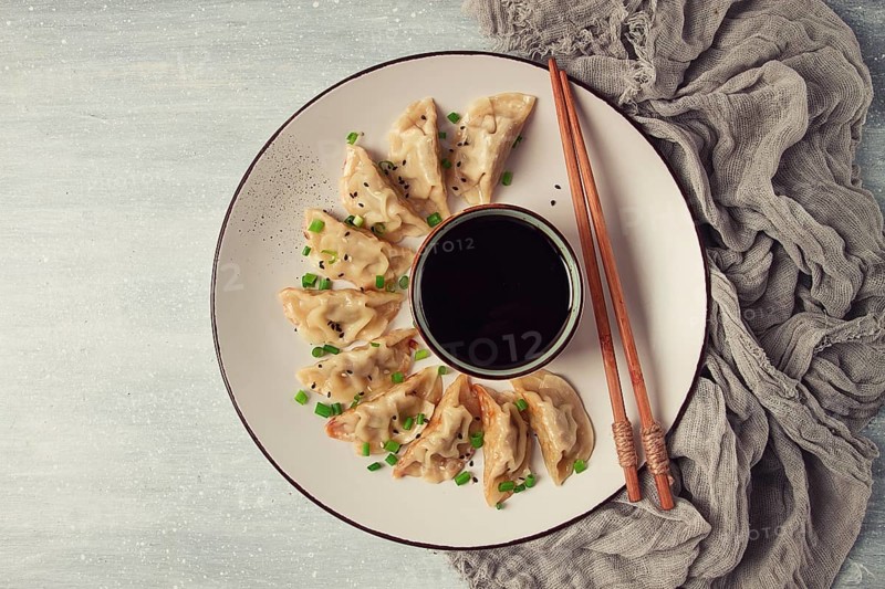 Japanese Gyoza dumplings, fried, with sauce, top view, without people, tinted, selective focus