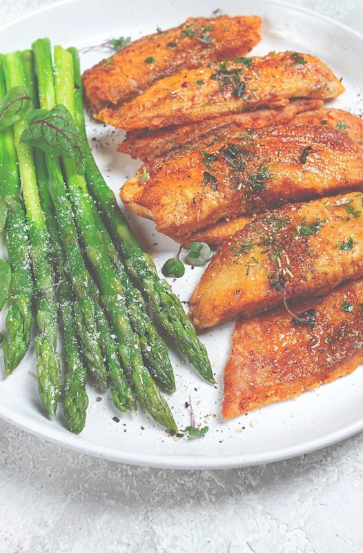 Fried fish fillet, tilapia with asparagus, homemade, no people
