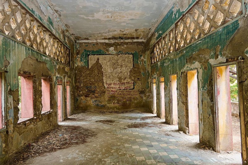 Abandoned room with large windows and peeling paint on walls, partially preserved decorations and incipient vegetation, Italian Governor's Palace, Ruins, Italian colonial settlement, Eleousa, Rhodes, Dodecanese, Greek Islands, Greece, Europe