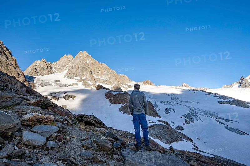 Mountaineer in mountain landscape, rocky summit of Aiguille du Tour and Glacier du Tour in the evening light, glacier and mountain peak, Chamonix, Haute-Savoie, France, Europe