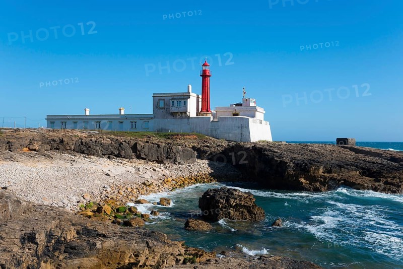 Old lighthouse on a rocky coast under a clear blue sky, Farol do Cabo Raso, São Brás de Sanxete fortress, Estoril, Cascais, Parque Natural de Sintra-Cascais, Portugal, Europe