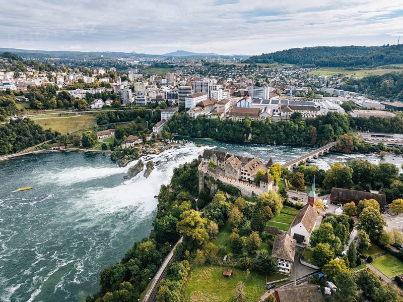 Aerial view of the Rhine Falls with Laufen Castle with autumnal vegetation, on the horizon the town of Neuhausen, and Schaffhausen, Canton of Zurich, Switzerland, Europe