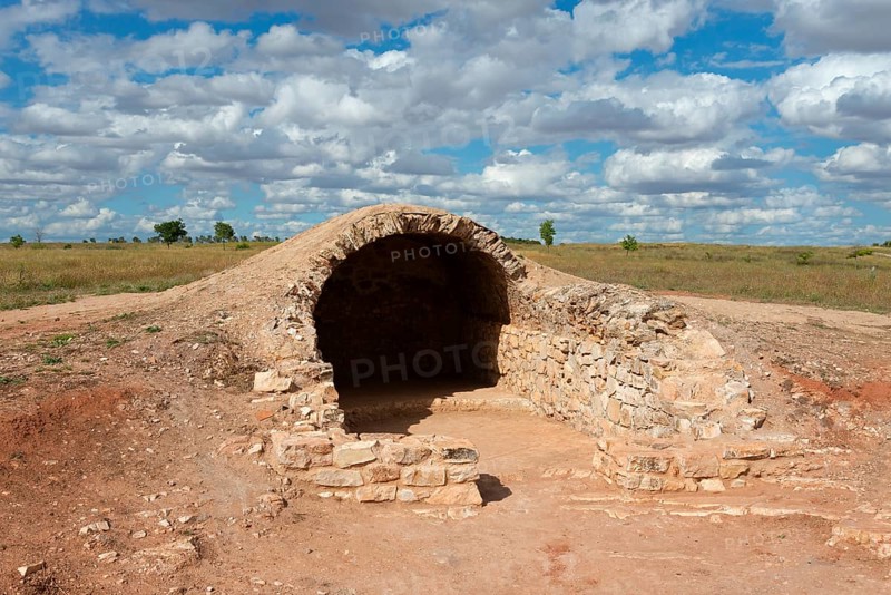 A stone vault in an archaeological site under a cloudy sky, Cueva, cave, Cerro de los molinos, mill hill, Campo de Criptana, Ciudad Real province, Castilla-La Mancha, Don Quixote route, Spain, Europe