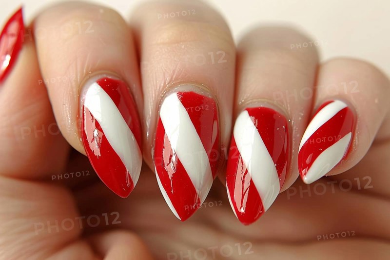 Close up of woman's fingernails with red and white colored nail polish with seasonal Christmas candy cane themed design. Generative Ai, AI generated