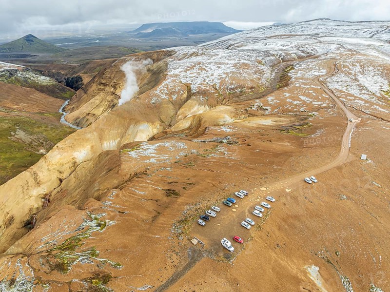 Steaming hot springs and colourful rhyolite mountains, parking lot, aerial view, Hveradalir geothermal area, Kerlingarfjöll, Icelandic highlands, Iceland, Europe