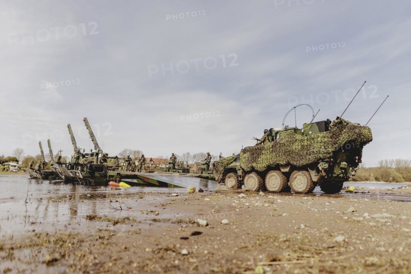 A Pandur II tank navigates the Bundeswehr's Amphibie M3 floating high-speed bridge in the Elbe as part of the military exercise 'Wettiner Schwert' with German and Czech soldiers near Tangermünde, 26 March 2024. 'Wettiner Schwert' is part of the NATO Quadriga exercise