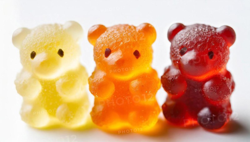 Transparent gummy bears in the colours yellow, orange and red with visible texture, gummy bears, AI generated, AI generated