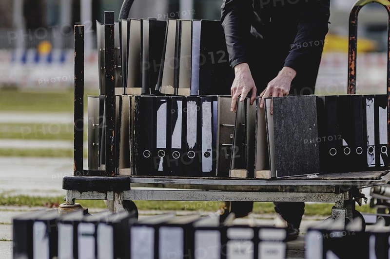 Files are cleared away after a protest action by the German Confederation of Skilled Crafts in front of the Federal Chancellery in Berlin, 26 February 2024. The German Confederation of Skilled Crafts demonstrates against the economic policy of the federal government as well as the high level of bureaucracy and the improvement of location conditions