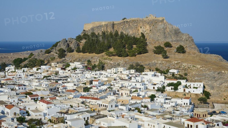 Whitewashed houses of a mountain village under an old fortress on a sunny day, Acropolis of Lindos, Lindos, Rhodes, Dodecanese, Greek Islands, Greece, Europe