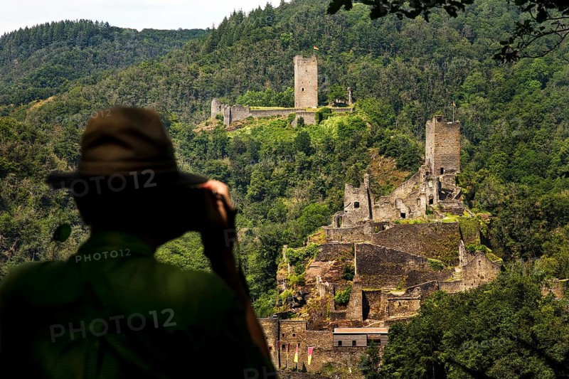A man photographs the two castles, Oberburg and Niederburg of Manderscheid, South Eifel, Eifel, Rhineland-Palatinate, Germany, Europe