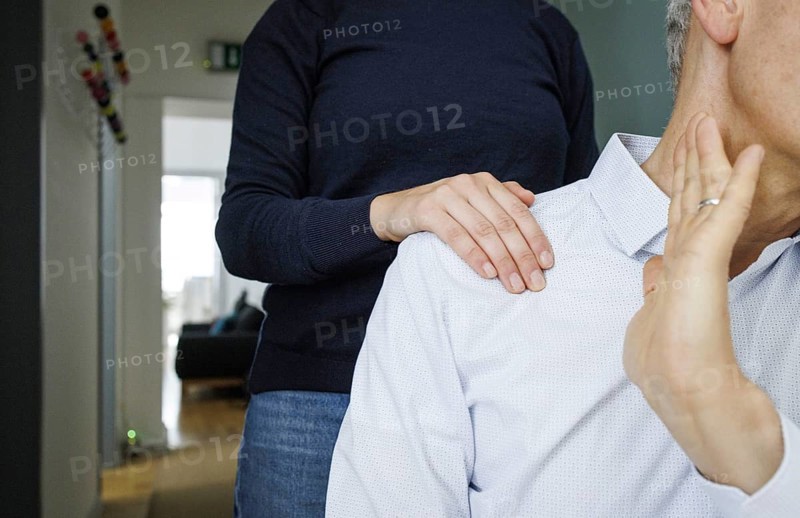 Harassment in the workplace. A woman puts her hand on the shoulder of a man in an office in Berlin, 09/08/2024