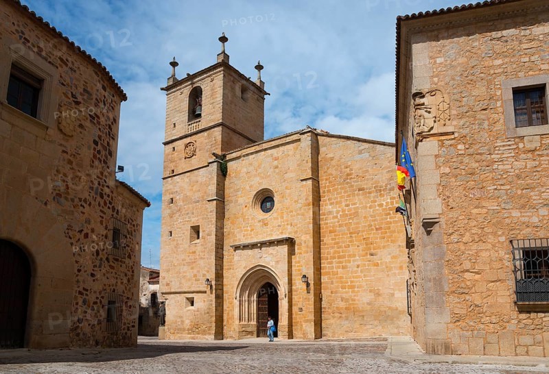 Stone building with bell tower and a person in front of the entrance in daylight, Cathedral, Concathedral, Iglesia de Santa Maria, Old Town, Co-Cathedral Santa María de Cáceres, Cáceres, Caceres, Extremadura, Spain, Europe