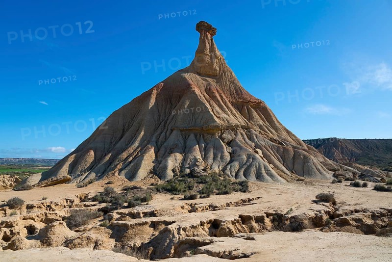 A large rock rises out of a sandy desert under a clear blue sky, Castildetierra, Bardenas Reales Natural Park, desert, semi-desert, Navarre, Nafarroa, UNESCO Biosphere Reserve, Spain, Europe