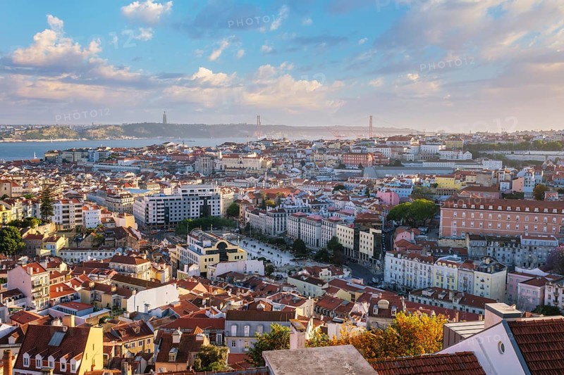 View of Lisbon famous view from Miradouro da Senhora do Monte tourist viewpoint of Alfama and Mauraria old city districts, 25th of April Bridge on sunset. Lisbon, Portugal, Europe