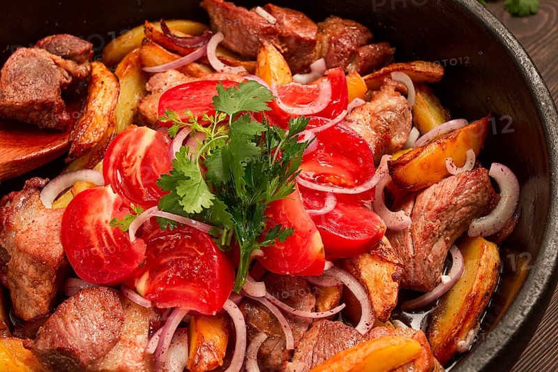 Ojakhuri, Traditional Georgian dish, fried potatoes with meat, in a clay frying pan, top view, no people, homemade