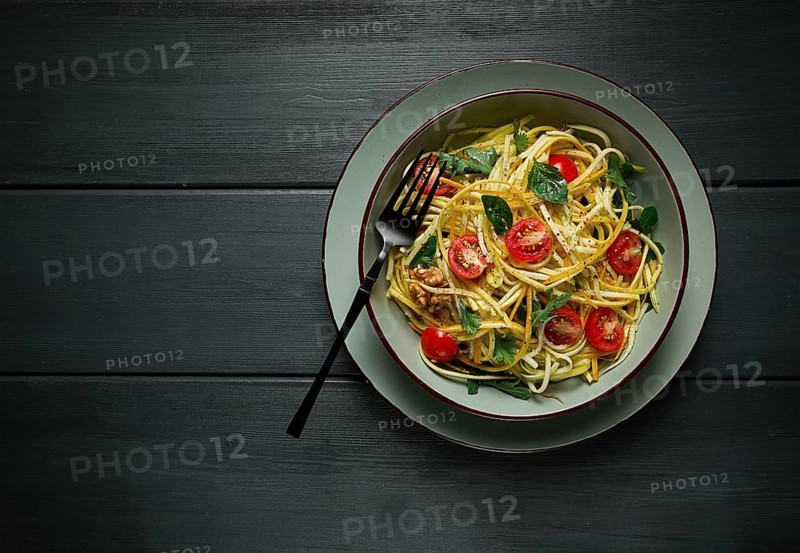 Yellow zucchini salad, with cherry, vegetarian food, sliced into strips, homemade