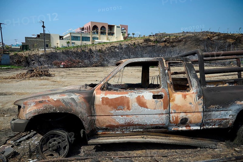 Destroyed lorry in a devastated landscape with burning trees and a building in the background, forest fires, summer 2023, forest fire damage, Boutique 5 Hotel, Kiotari, Rhodes, Rhodes, Dodecanese, Greek Islands, Greece, Europe