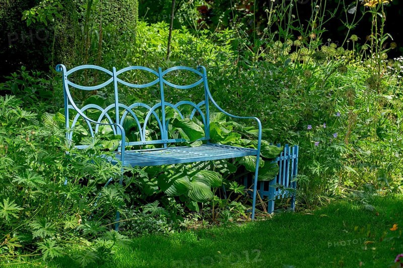Blue bench in the district educational garden, Burgsteinfurt, Steinfurt, Münsterland, North Rhine-Westphalia, Germany, Europe