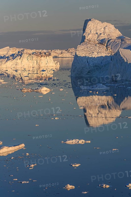 Icebergs and ice floes reflected in the water, summer, midnight sun, Jakobshavn glacier and ice fjord, Ilulissat Kangerlua, Disko Bay, West Greenland, Greenland, North America