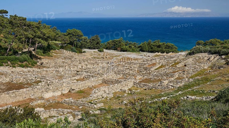 Ruins of an ancient site in front of a blue sea and tree-lined terrain, Kamiros, Archaeological site, Ancient city, Foundation of Doric Greeks, Rhodes, Dodecanese, Greek Islands, Greece, Europe