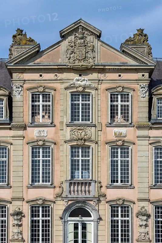 Façade with high relief architectural ornaments above windows of 1750 Poeke Castle, Kasteel van Poeke in Rococo style, Aalter, East Flanders, Belgium, Europe
