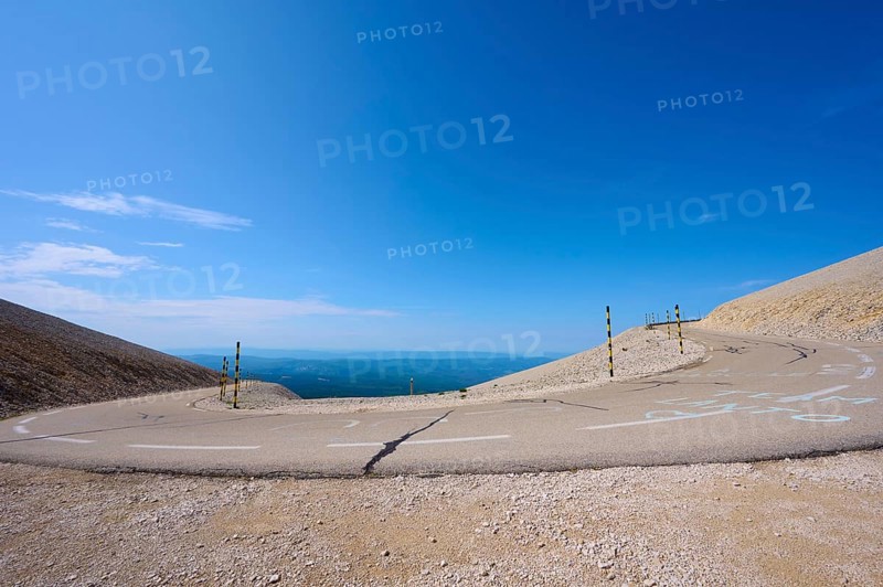 An empty mountain road with a hairpin bend under a clear blue sky and barren landscape, Mont Ventoux, Vaucluse department, Provence, France, Europe