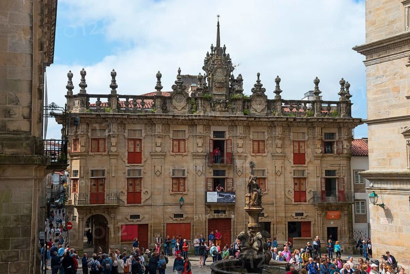 Baroque building with decorative façade and many visitors in the foreground on a sunny day, Casa do Cabido, Sala de Exposicións, exhibition and trade centre, Fonte dos Cabalos, Fountain of the Horses, Praza das Praterías, Santiago de Compostela, autonomous community of Galicia, place of pilgrimage, destination of the Way of St. James, Spain, Europe