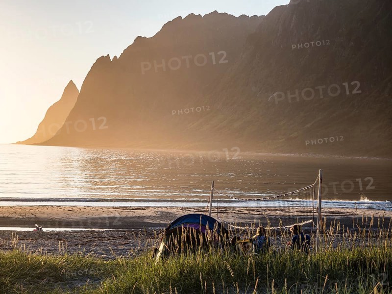 Beach Ersfjordstranden, fjord Ersfjord, public recreation area, sunset, beach volleyball, view to mountain range Okshornan, island Senja, Troms, northern Norway, Norway, Europe