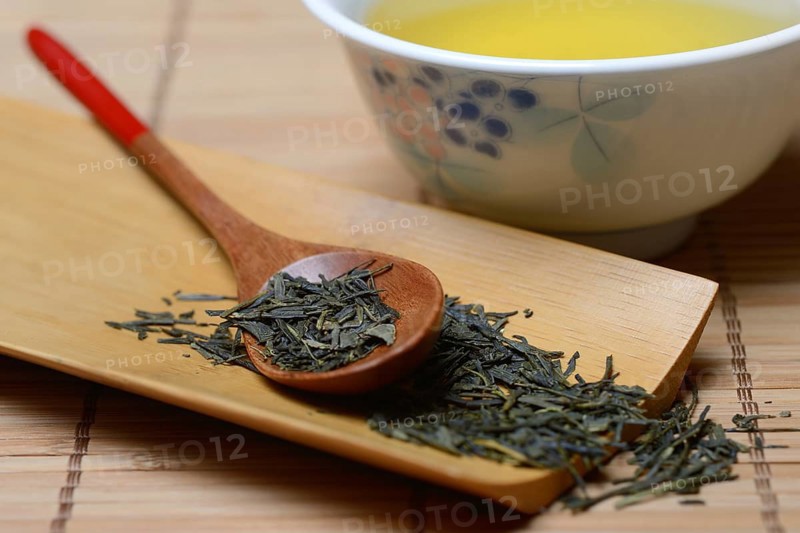 Green Sencha tea in tea bowl and tea leaves in wooden spoon, green tea, Japan, Asia