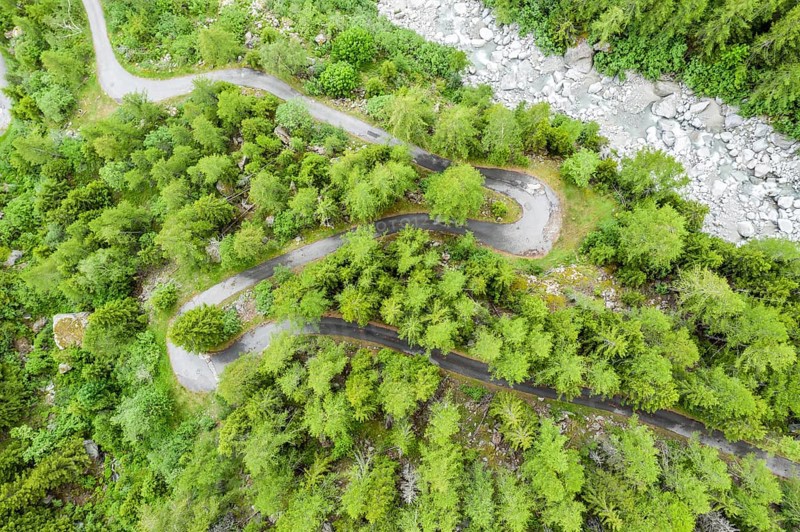 Aerial view, drone shot, windy road along a river, mountain valley, Switzerland, Europe