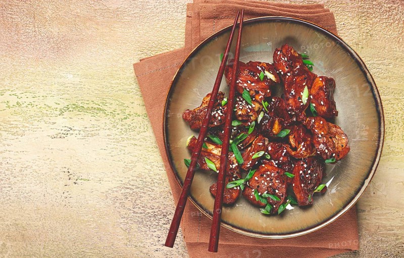 Yakitori chicken kebab, on a plate, with green onions and sesame seeds, top view, no people