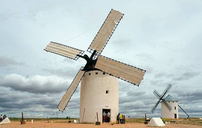Large white windmills in an open landscape with dramatic skies and cloud formations, Campo de Criptana, Ciudad Real province, Castilla-La Mancha, Don Quixote Route, Spain, Europe