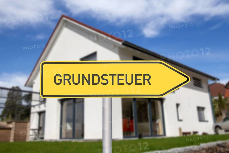 Symbolic image of property tax: directional arrow with the inscription GRUNDSTEUER in front of a detached house (Composing)