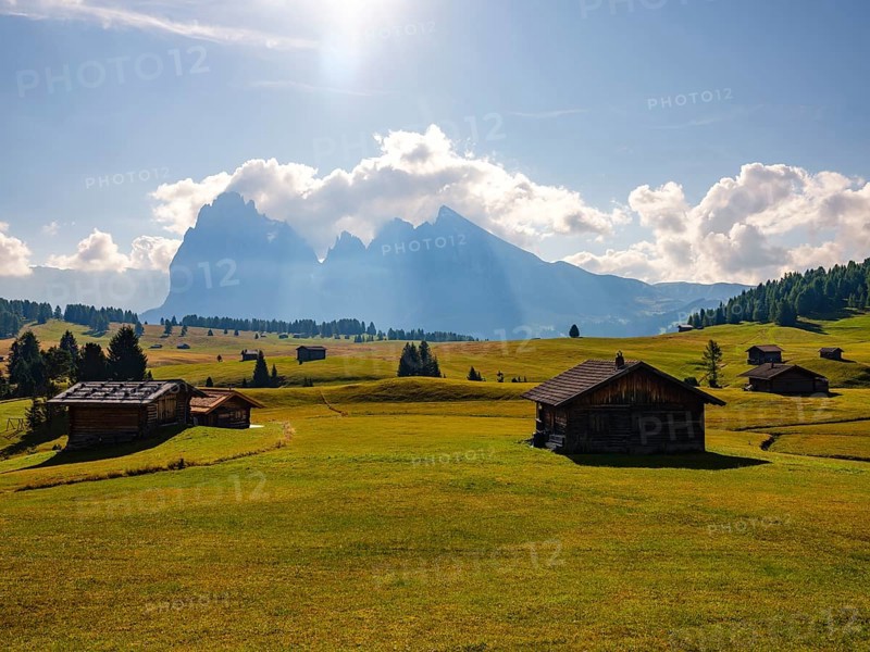 Alpine huts on autumn-coloured pastures in front of Sassolungo and Sassopiatto with clouds, Alpe di Siusi, Dolomites, South Tyrol, Italy, Europe