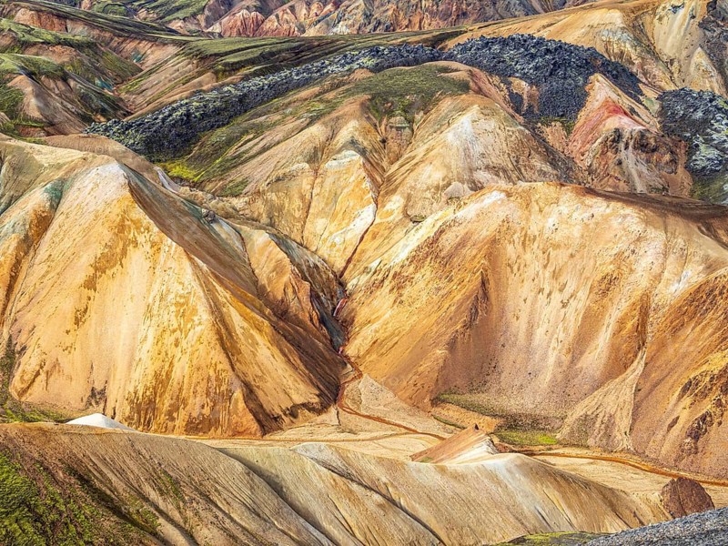 Colorful rhyolite mountains, lava field below mt. Brennisteinsalda, Landmannalaugar, Fjallabak Nature Reserve, Iceland, Europe