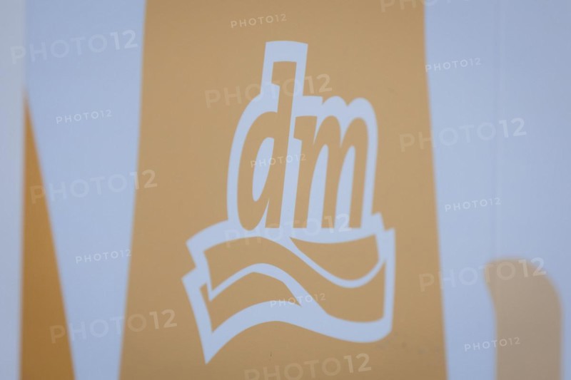 The logo of the drugstore chain DM is stuck on a window front in Berlin, 27/03/2024