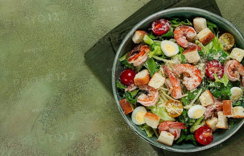 Caesar salad, with tiger prawns, shrimp salad, lettuce, quail eggs, cherry tomatoes, parmesan cheese, no people