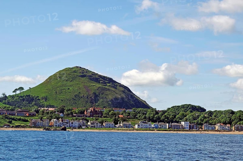 Coastal town with houses and a green hill in the background by the sea, North Berwick, Scotland, United Kingdom, Europe