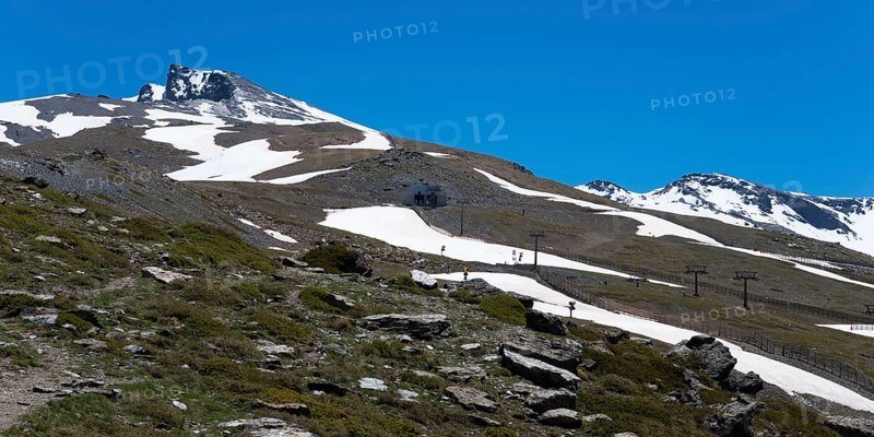 Snow-covered mountain with cable car supports and ski slopes under a blue sky, Pico del Veleta, Veleta peak, Hoya de la Mora, Maurin basin, Güéjar Sierra, Güejar, Sierra Nevada, Andalusia, Spain, Europe