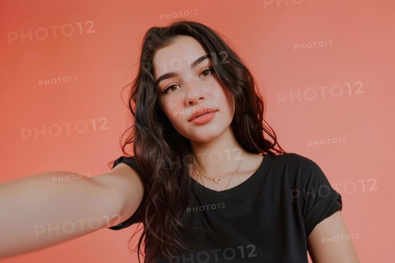 Young teenage girl taking selfie in front of pink studio background. KI generiert, generiert, AI generated