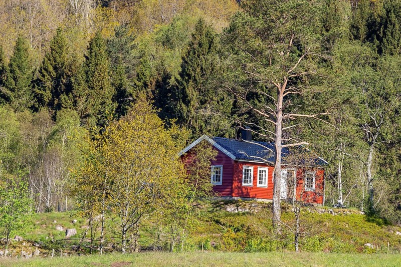 Typical red and white wooden norwegian house, near Cape Lindesnes at the Lenefjord, Norway, Europe