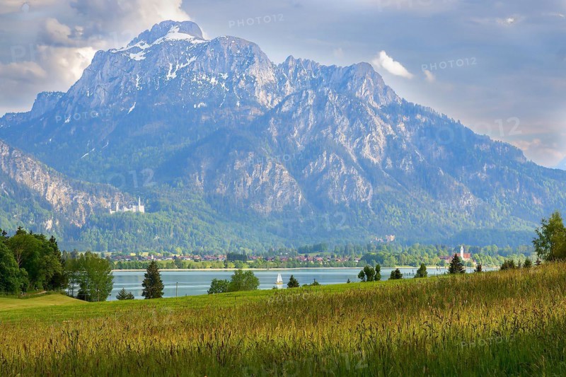 Lake Forggensee in front of the fairytale castles Schwanstein Castle and Hohenschwangau Castle in Schwangau Germany Europe