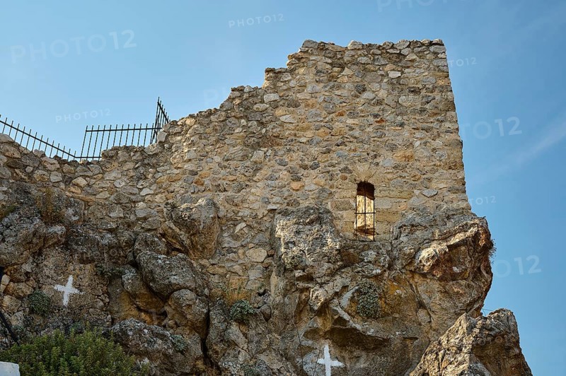 Historic stone wall with lattice and rocks, part of an ancient ruined architecture under a clear sky, St John's Castle, Archengelos village, Rhodes, Dodecanese, Greek Islands, Greece, Europe