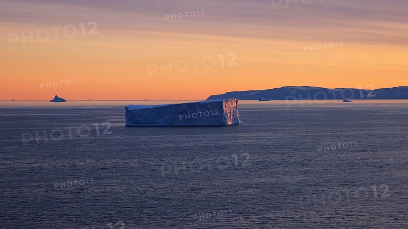 Iceberg seen from cruise ship vacation near Greenland coast in Arctic circle near Ilulissat Disko Bay